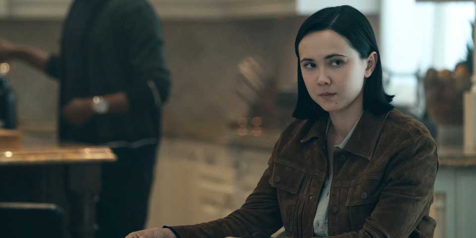 London Thor as Jordan Li sitting at a table in Gen V season 2