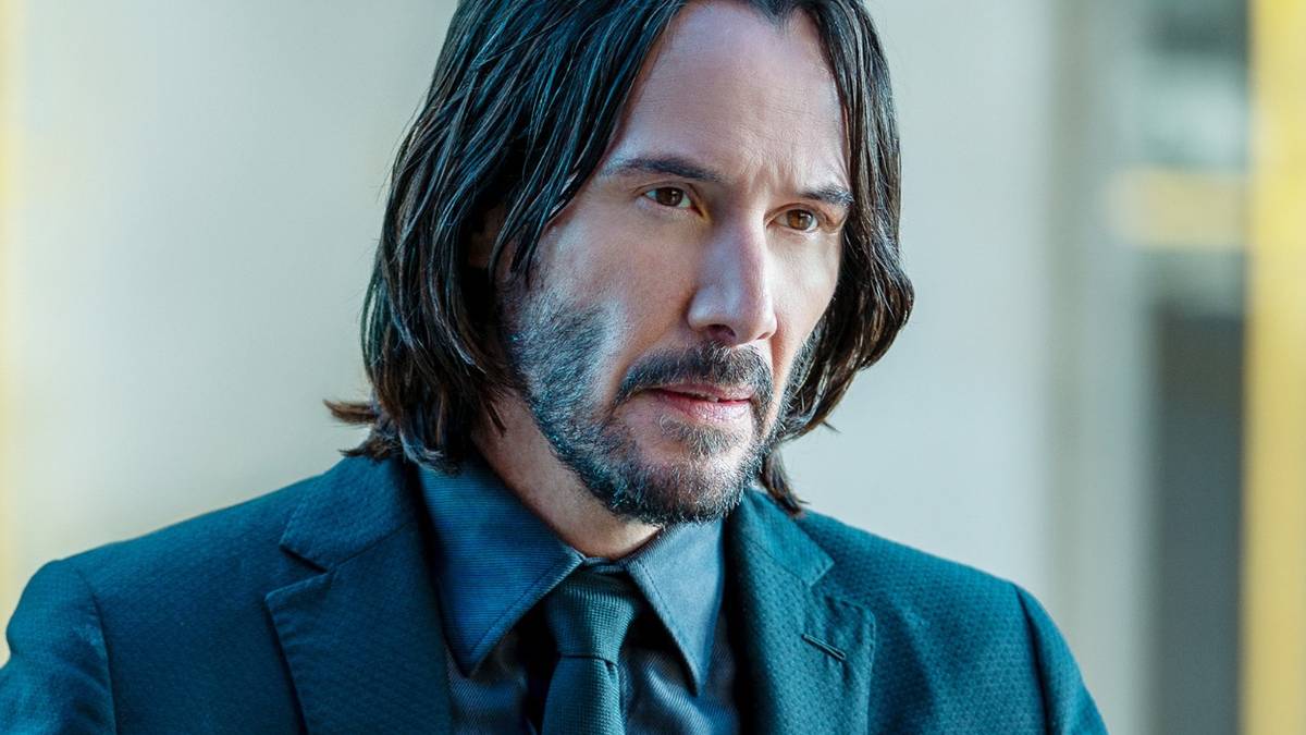 Keanu Reeves looking intense in a suit in John Wick Chapter 4