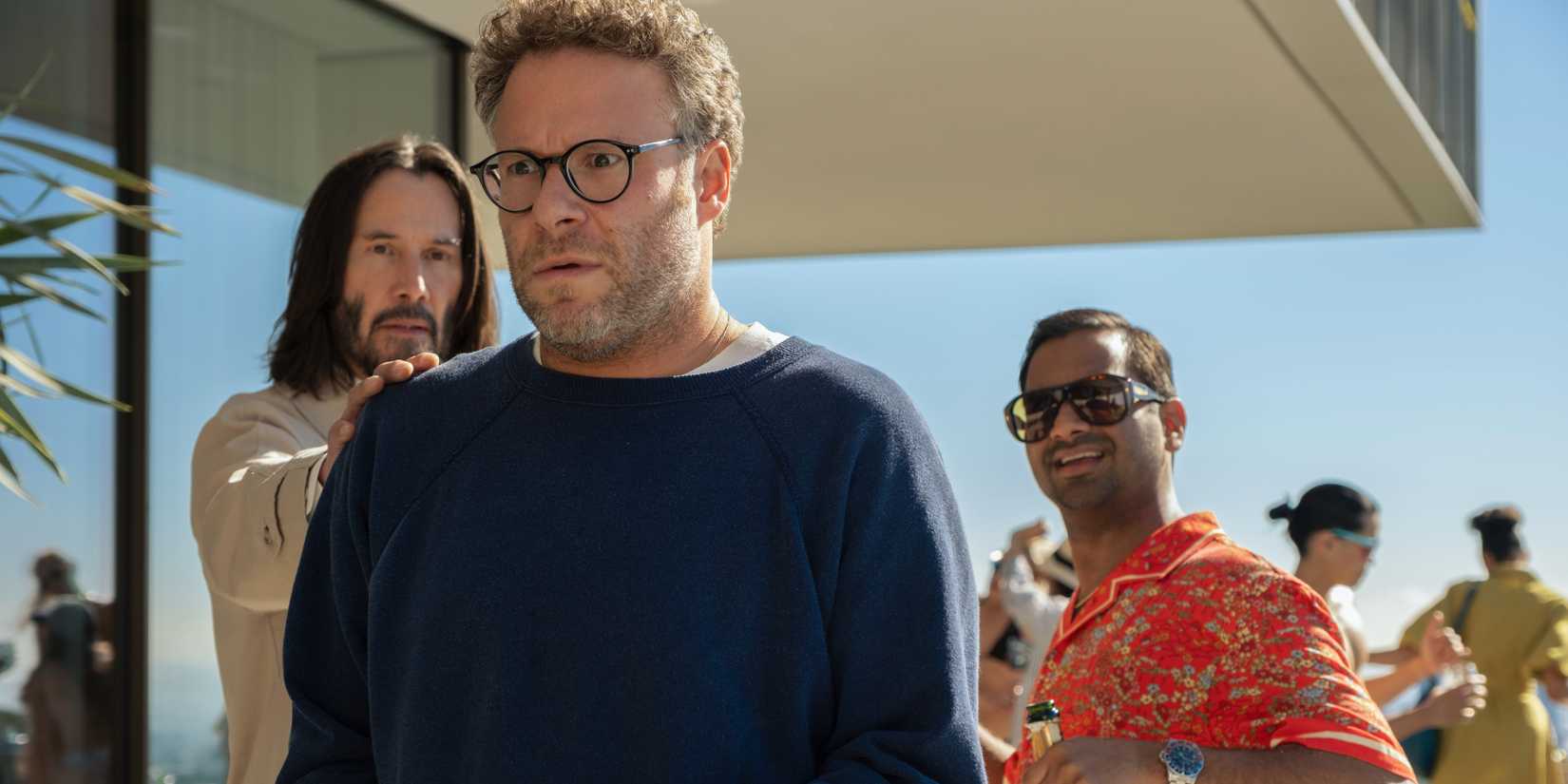 Keanu Reeves taps Seth Rogen's shoulder while Aziz Ansari looks on in Good Fortune