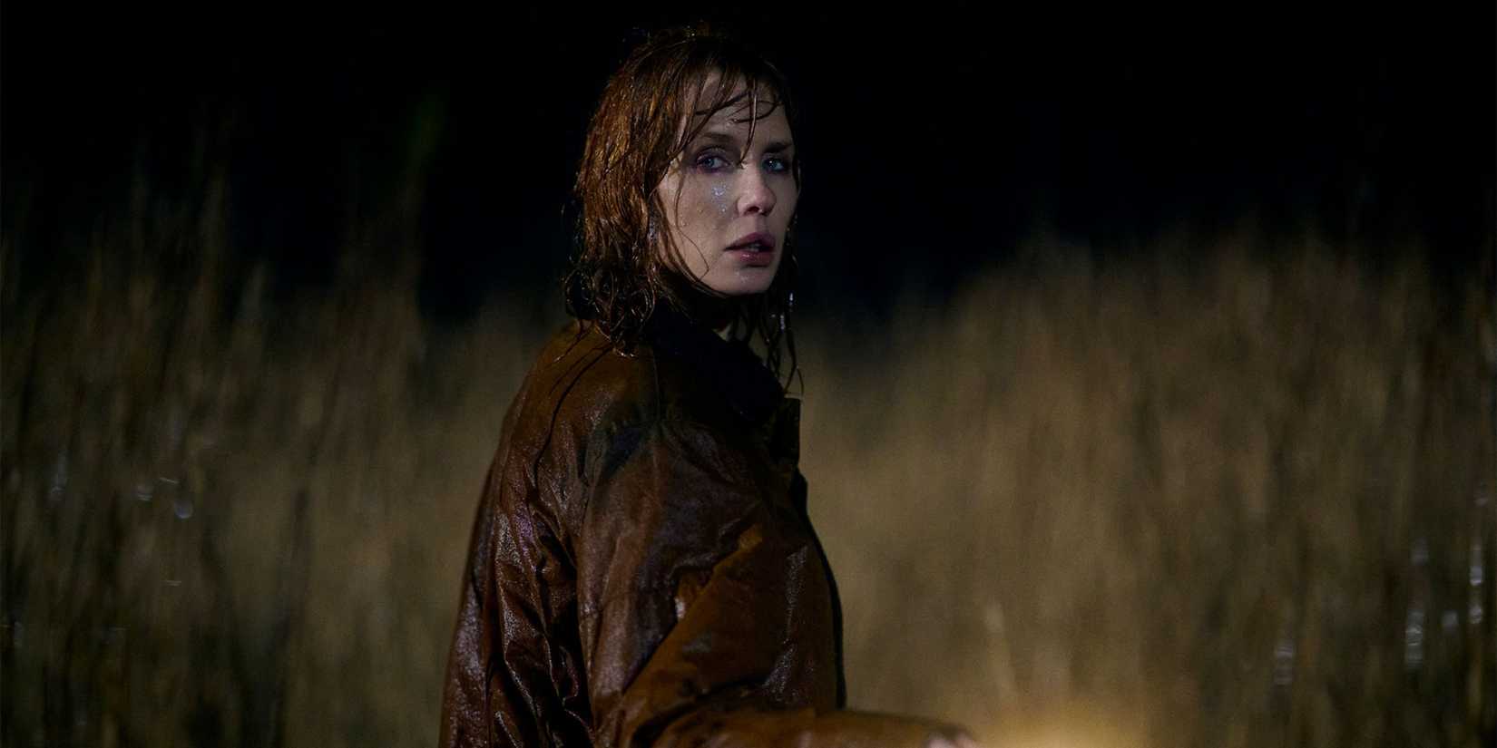 Kelly Reilly as Jackie Ellis in the rain with a flashlight in Under Salt Marsh 