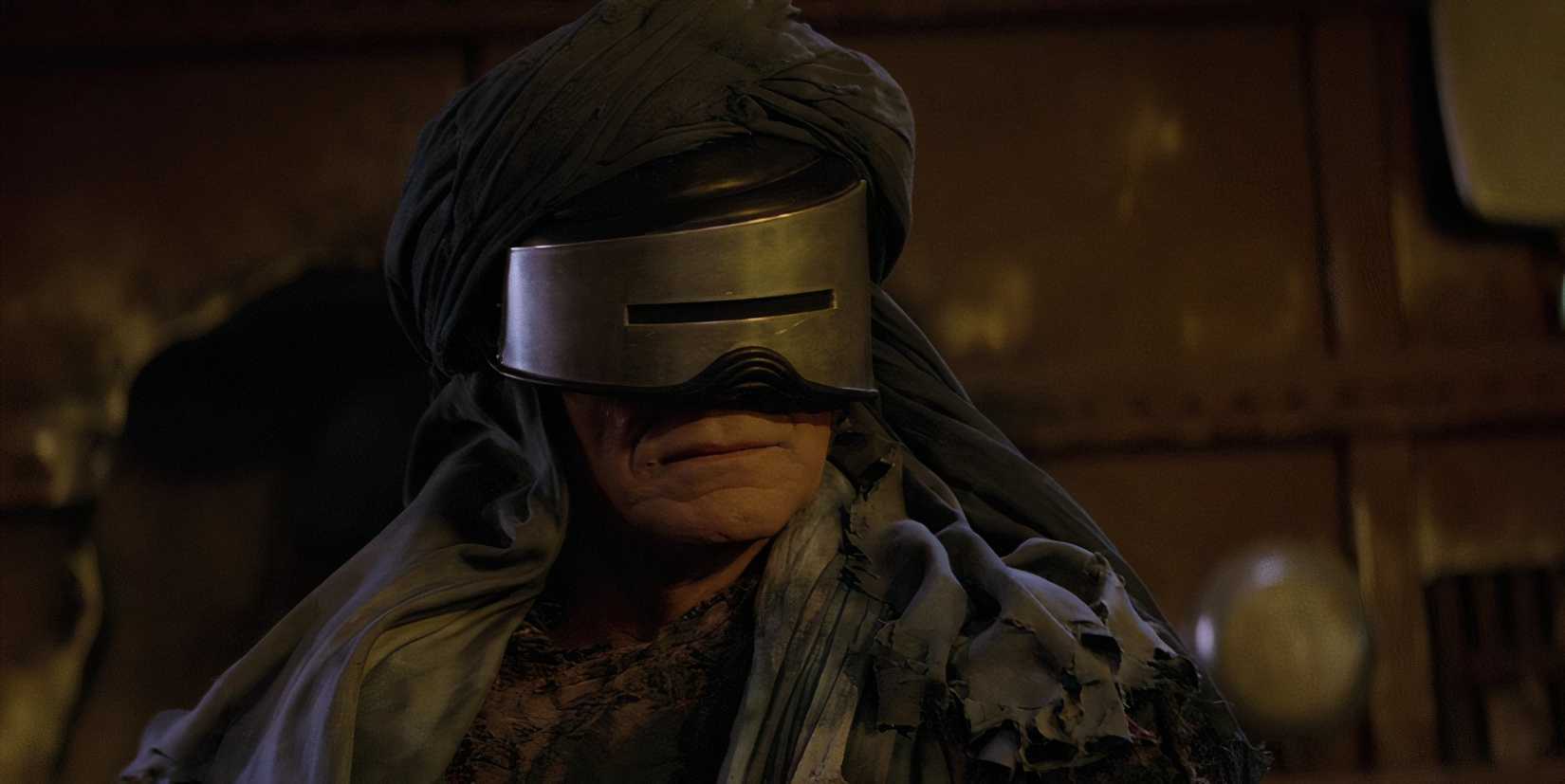 Khan wearing a hood and visor