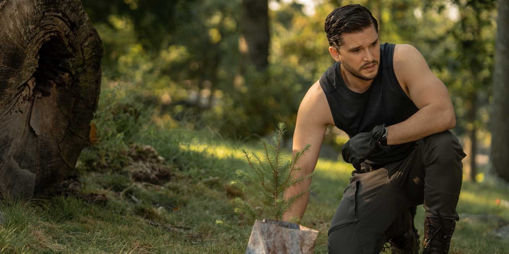 Kit Harington plants a tree in a scene from Extrapolations
