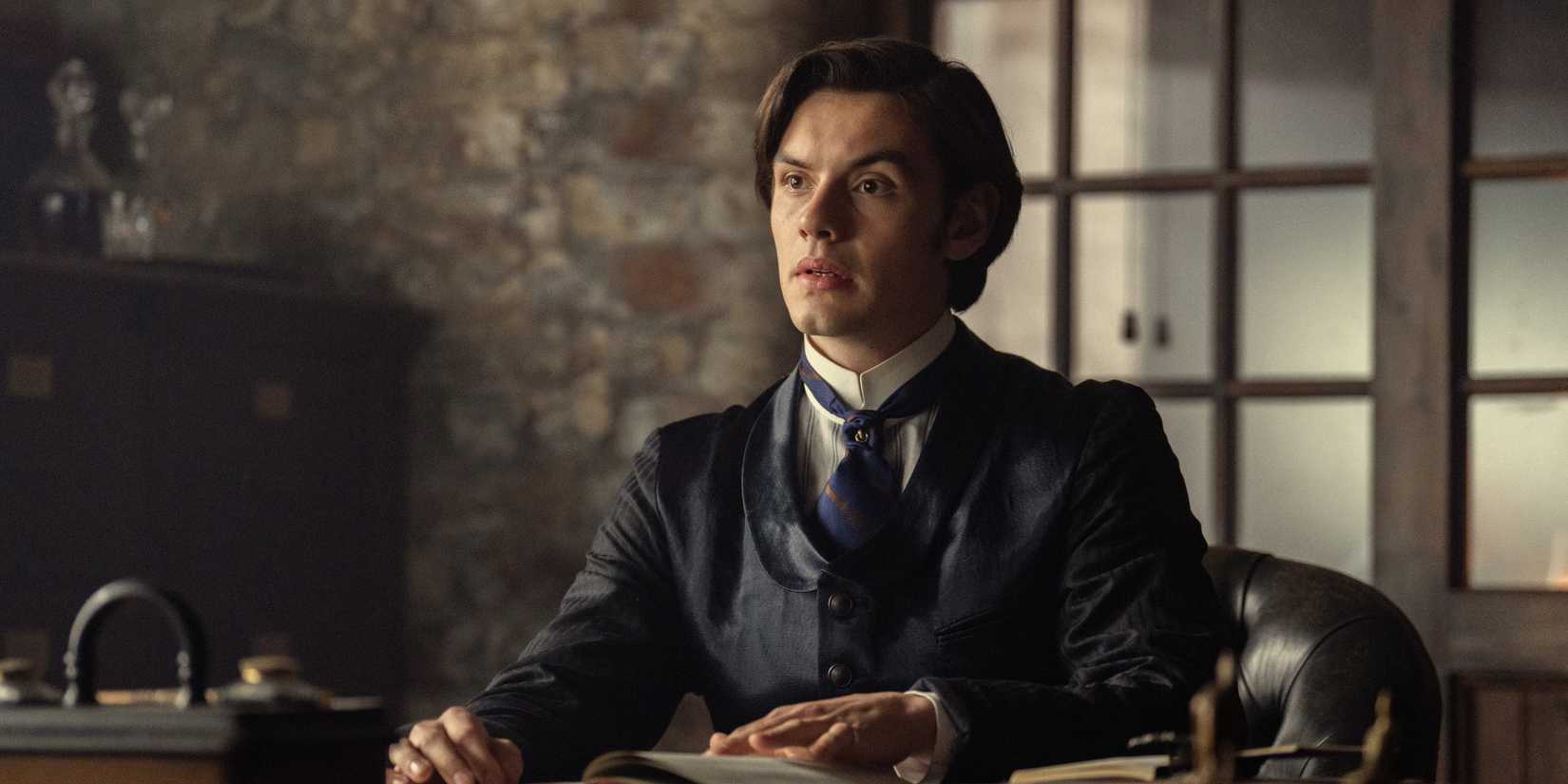 Louis Partridge as Edward Guinness sitting at a desk looking forward in House of Guinness
