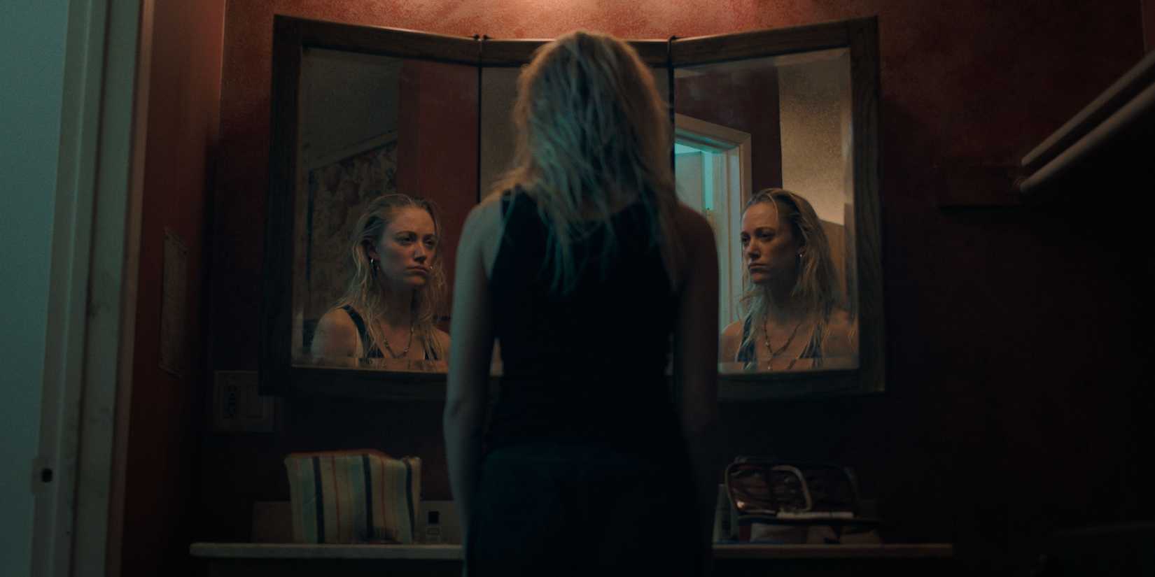Maika Monroe looking into a mirror in The Hand that Rocks The Cradle