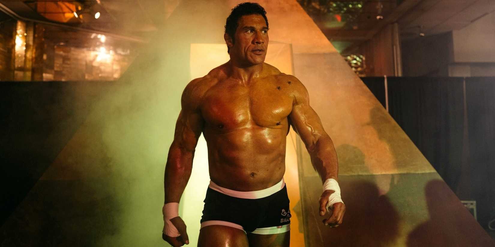 Dwayne Johnson as Mark Kerr walks into an arena in The Smashing Machine