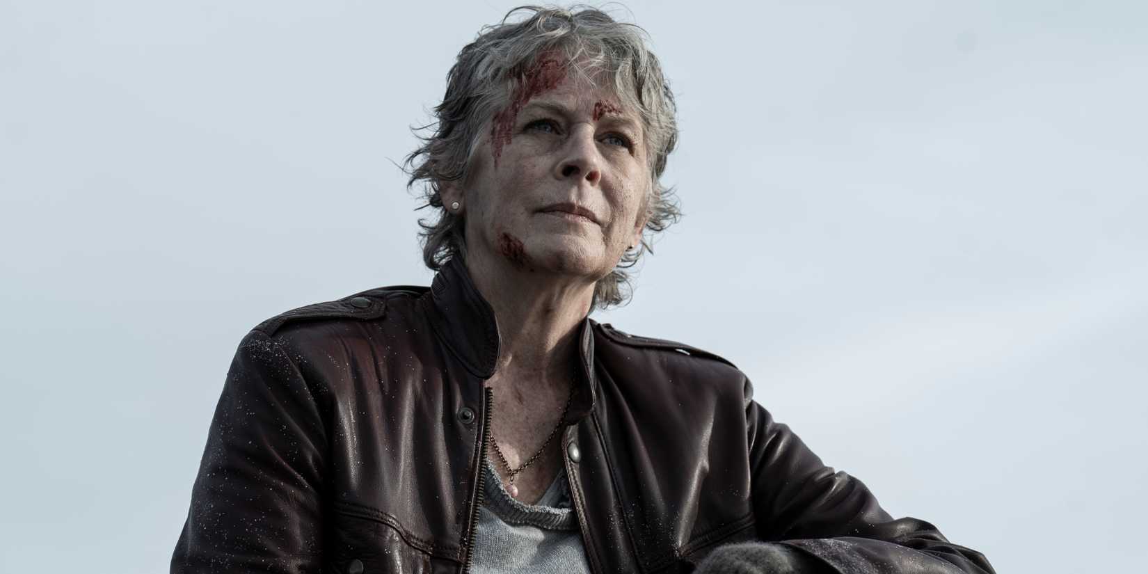Melissa McBride as Carol leaning on something and looking into the distance with blood on her head in The Walking Dead: Daryl Dixon