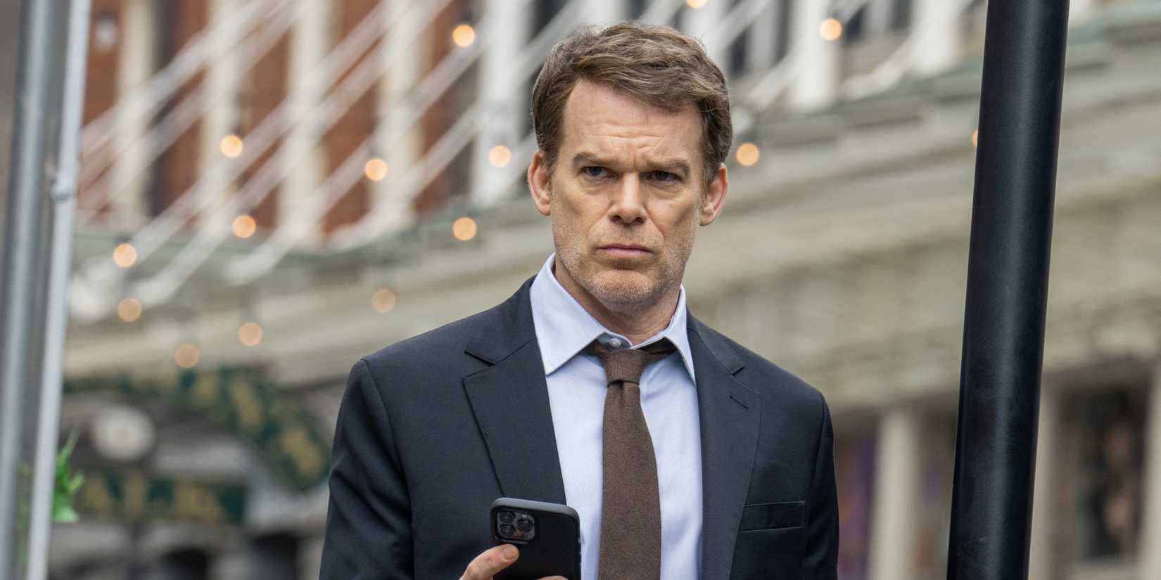 Michael C. Hall as Dexter Morgan holding his phone in Dexter Resurrection season 1