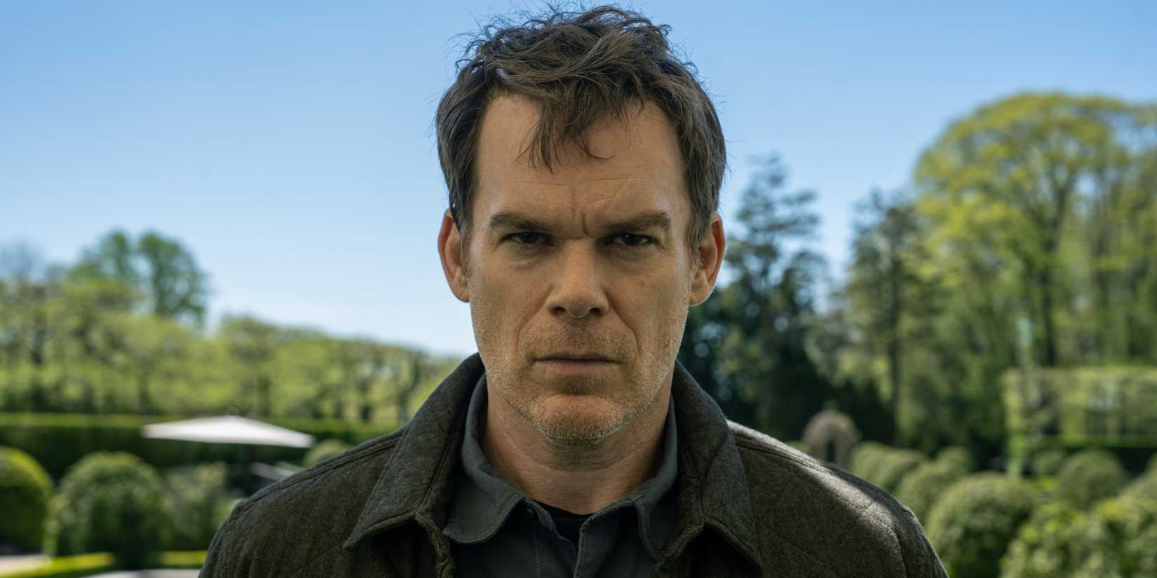 Michael C. Hall as Dexter Morgan looking stern with trees behind him in Dexter_ Resurrection