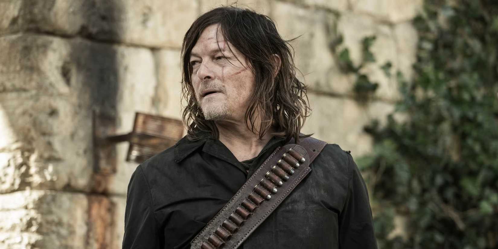 Norman Reedus as Daryl Dixon looking to the side while standing in front of a wall in The Walking Dead: Daryl Dixon season 3