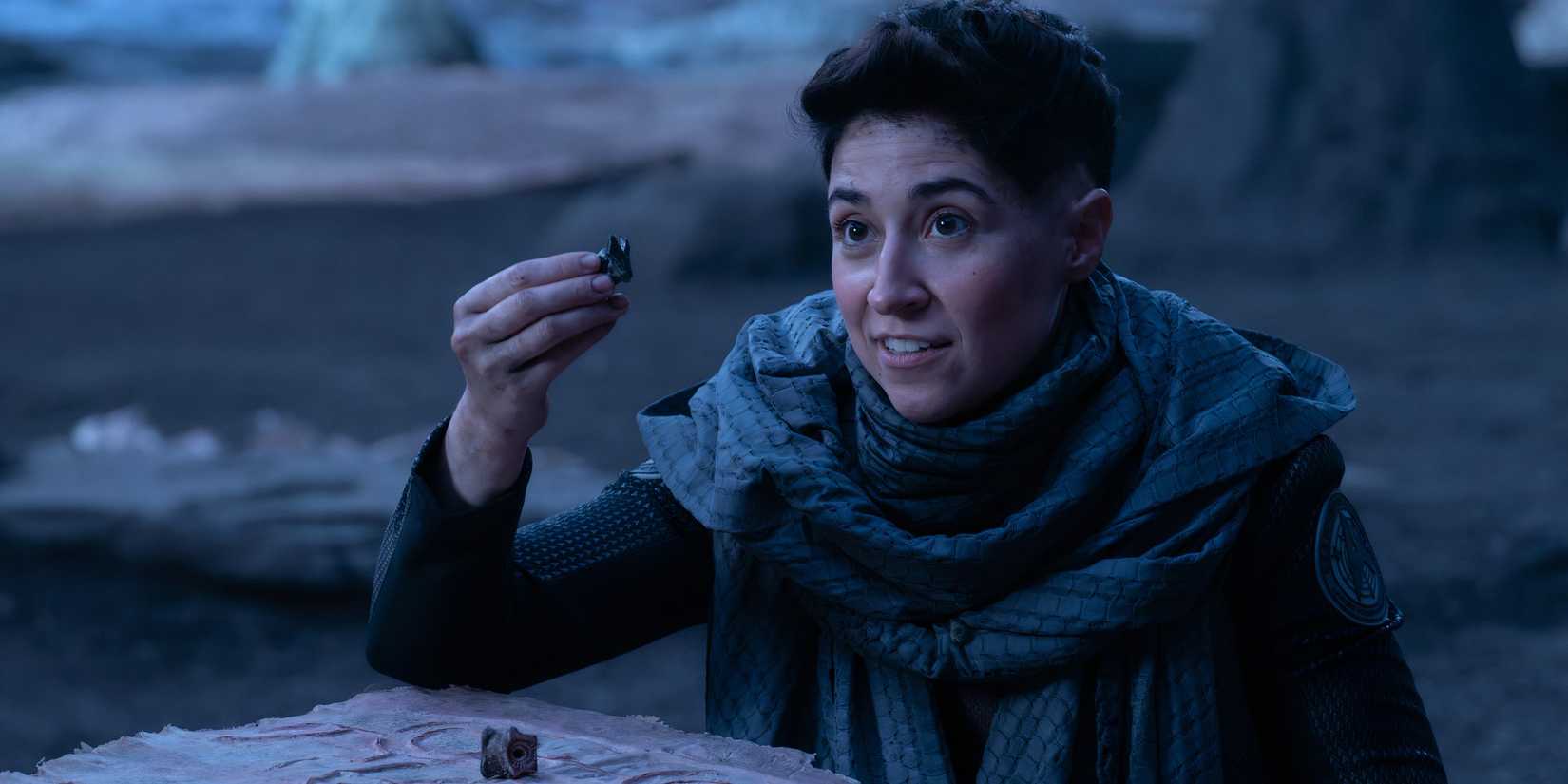 Ortegas holding up chess piece