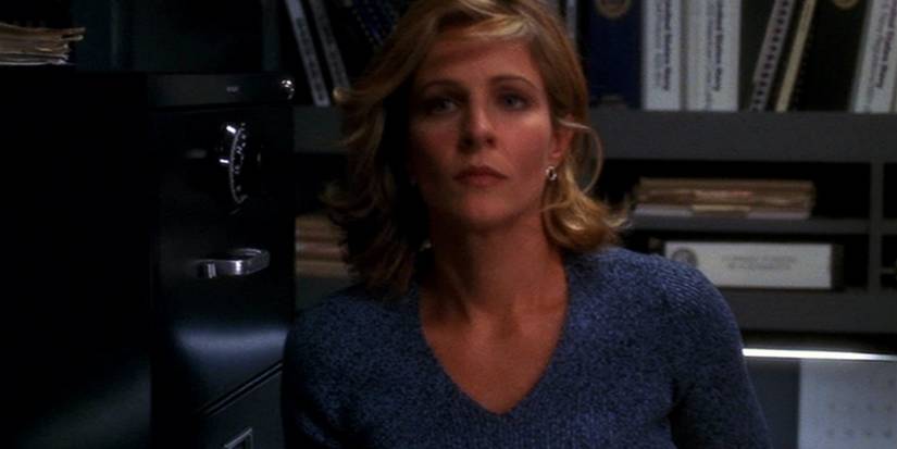 Paula Cassidy (Jessica Steen) next to a file cabinet and shelves in NCIS