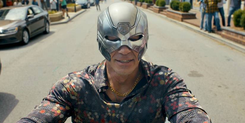 Peacemaker smiling and wearing his helmet in Alt Reality Peacemaker Season 2