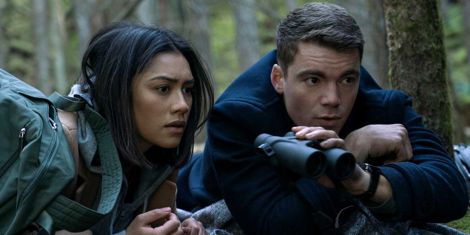 Peter and Rose looking through binoculars in The Night Agent