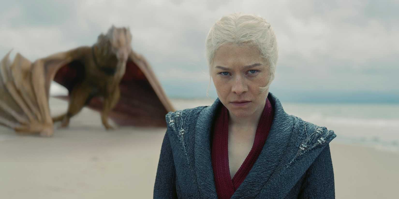 Queen Rhaenyra Targaryen looking angry with Syrax behind her on a beach in House of the Dragon season 2