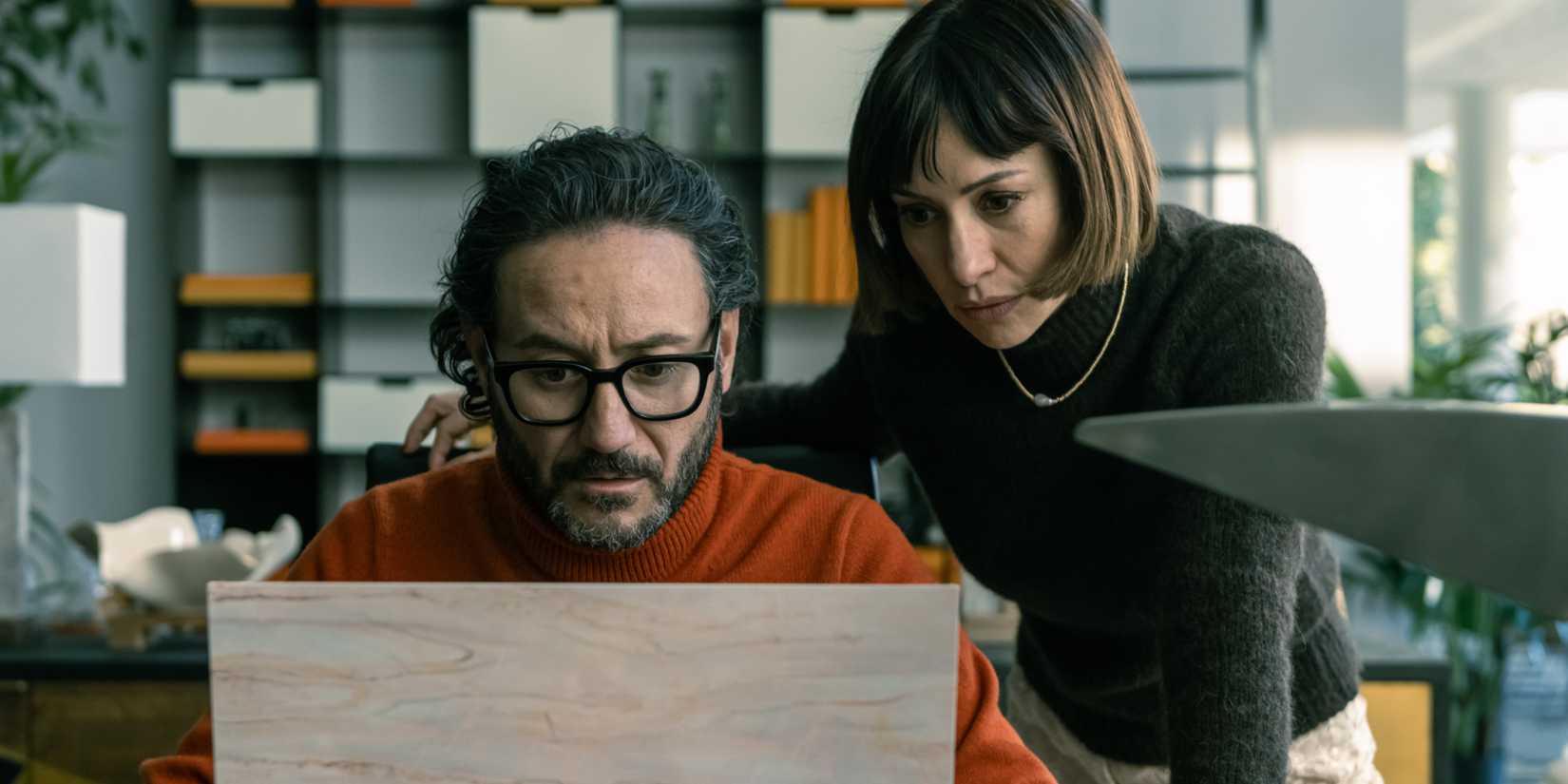 Rafa and Frida looking down at a block of wood in Billionaires' Bunker