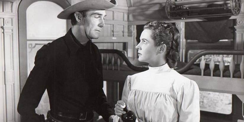 Randolph Scott talks to a woman in Canadian Pacific