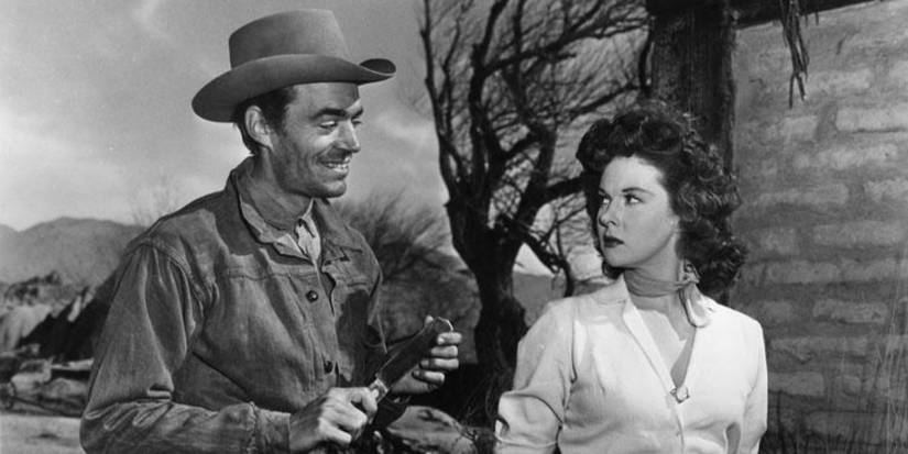 A man leers at a woman while holding a knife in Rawhide