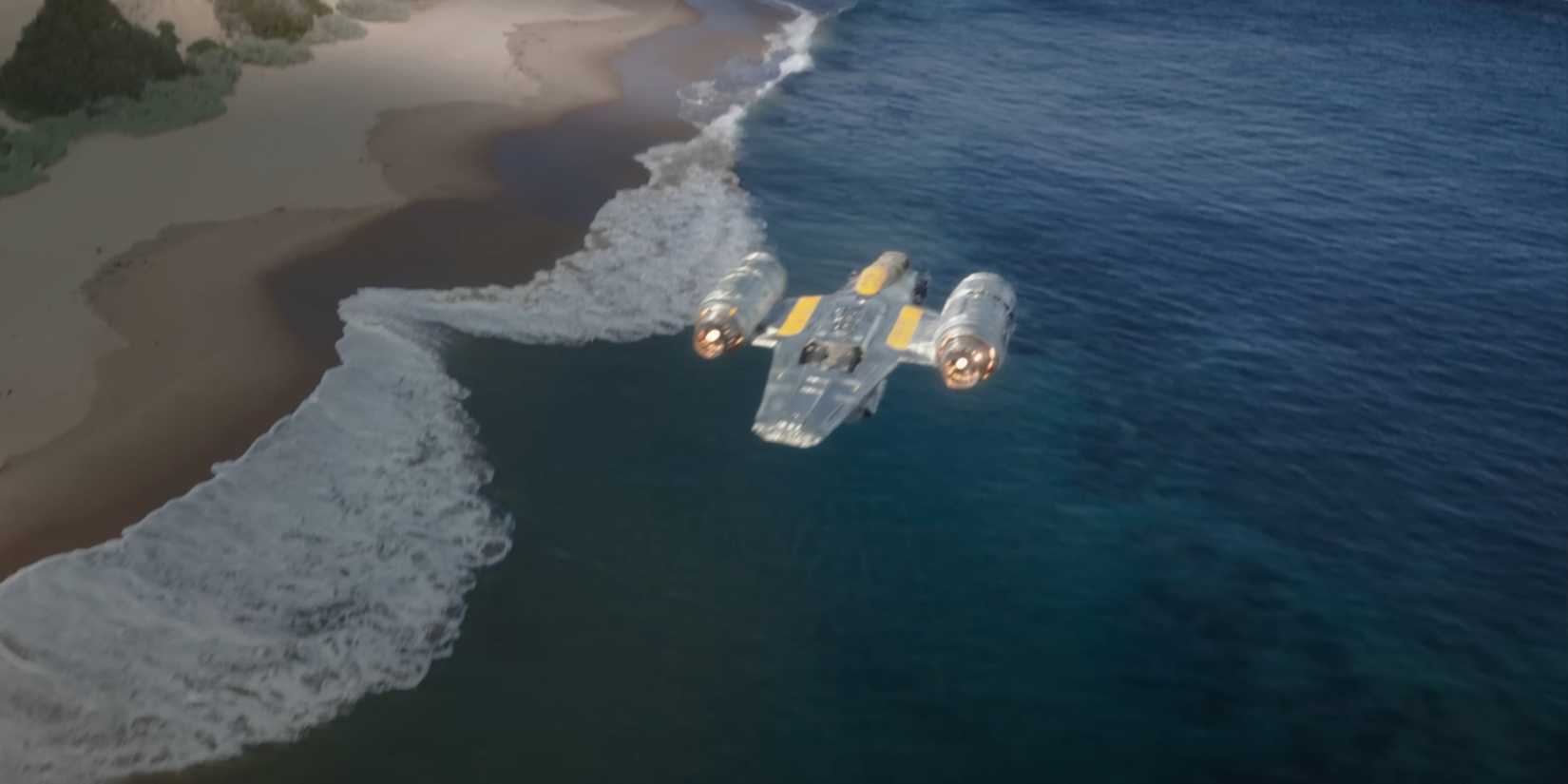 The new Razor Crest flies above the water and the shore of an unidentified planet.