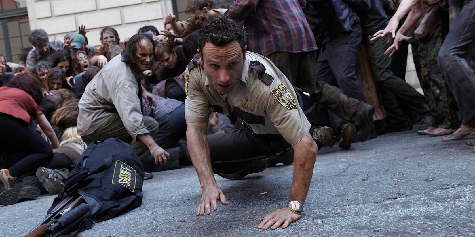 Rick surrounded by zombies in The Walking Dead season 1, episode 1