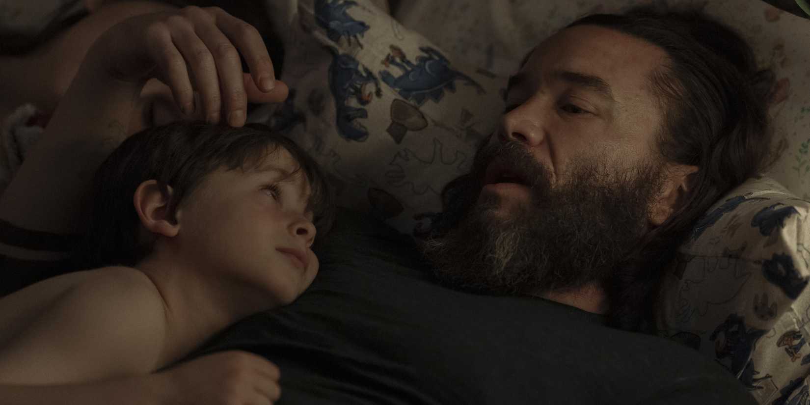 Robbie cuddling with his son in Task