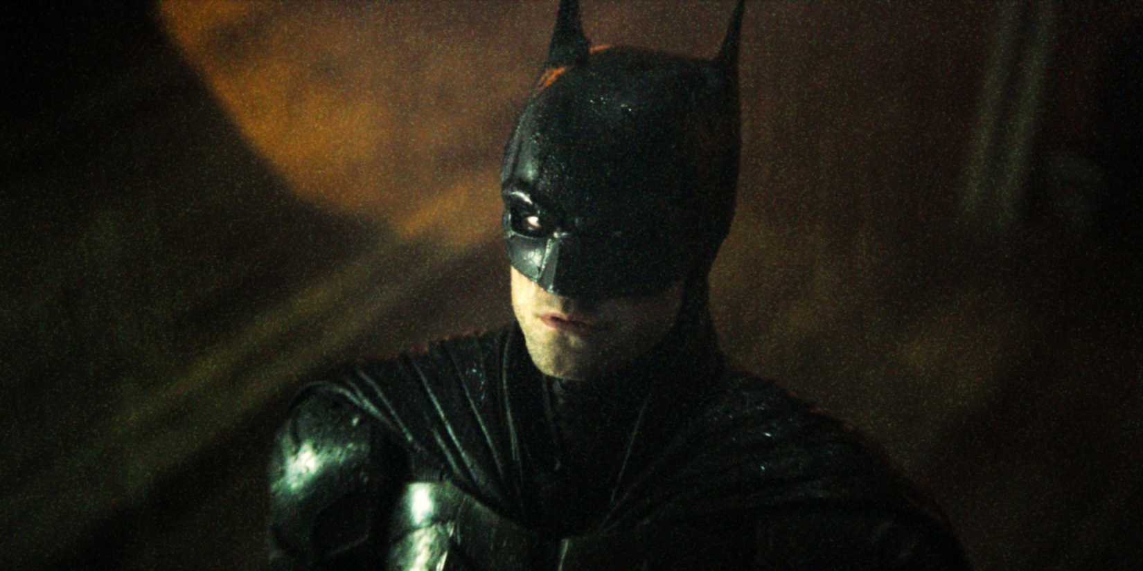 Robert Pattinson suited up as Batman looking up in The Batman