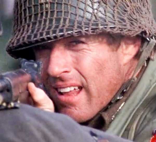 Robert Redford as Major Julian Cook aiming a gun in A Bridge Too Far