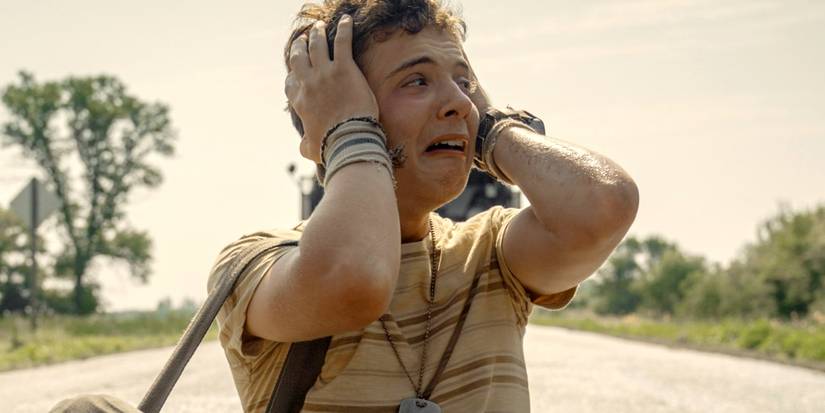 Roman Griffin Davis clutching his head in fear in The Long Walk