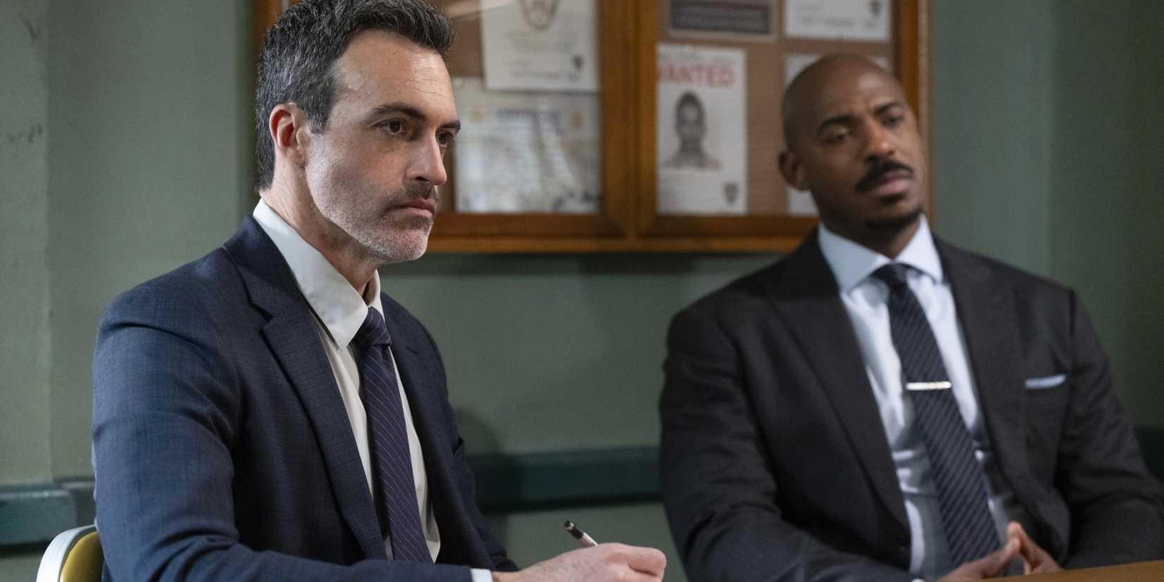 Reid Scott and Mehcad Brooks in an interview room in Law & Order