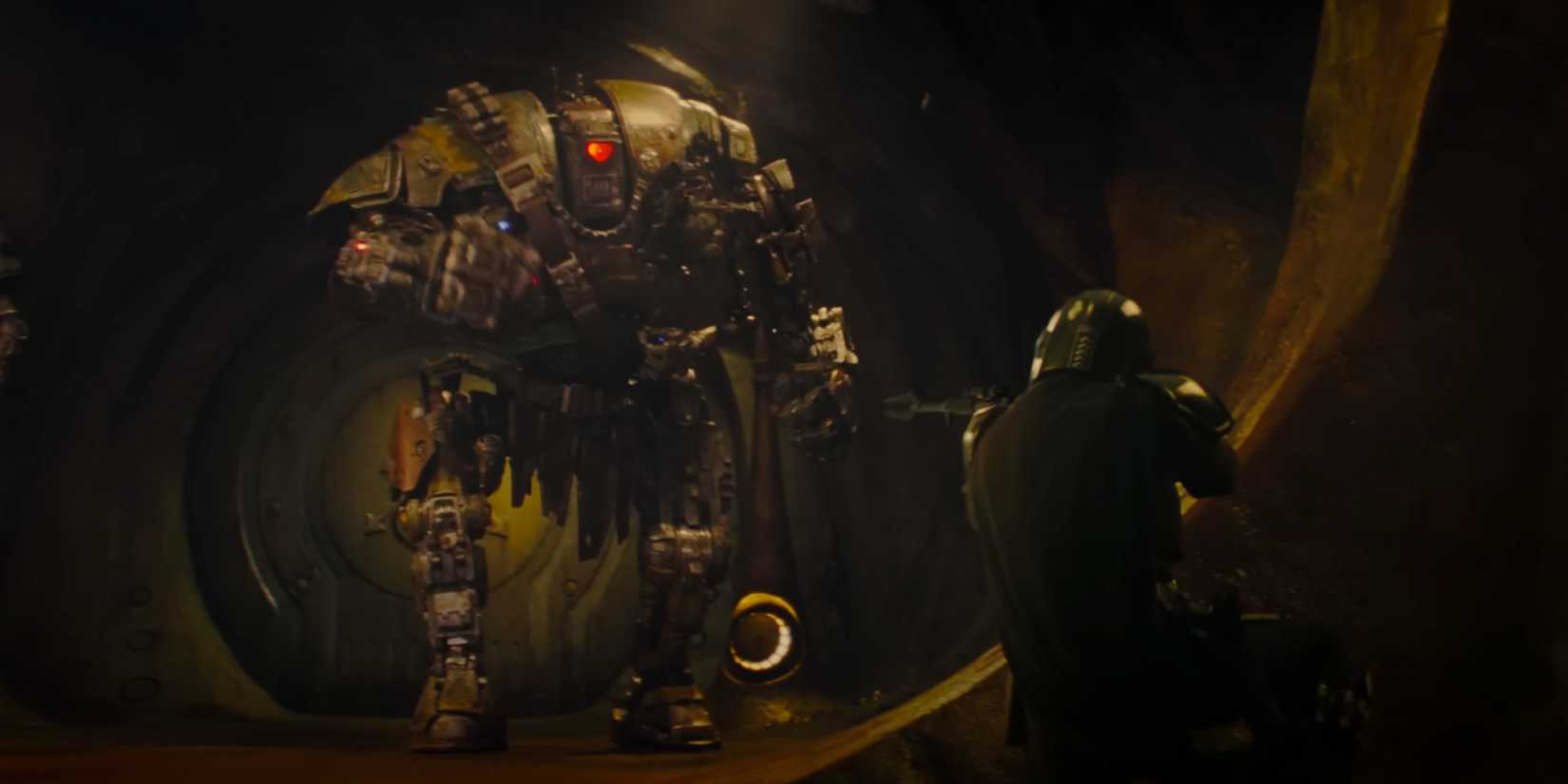 Din Djarin takes aim at an advanced battle droid with his pulse rifle.