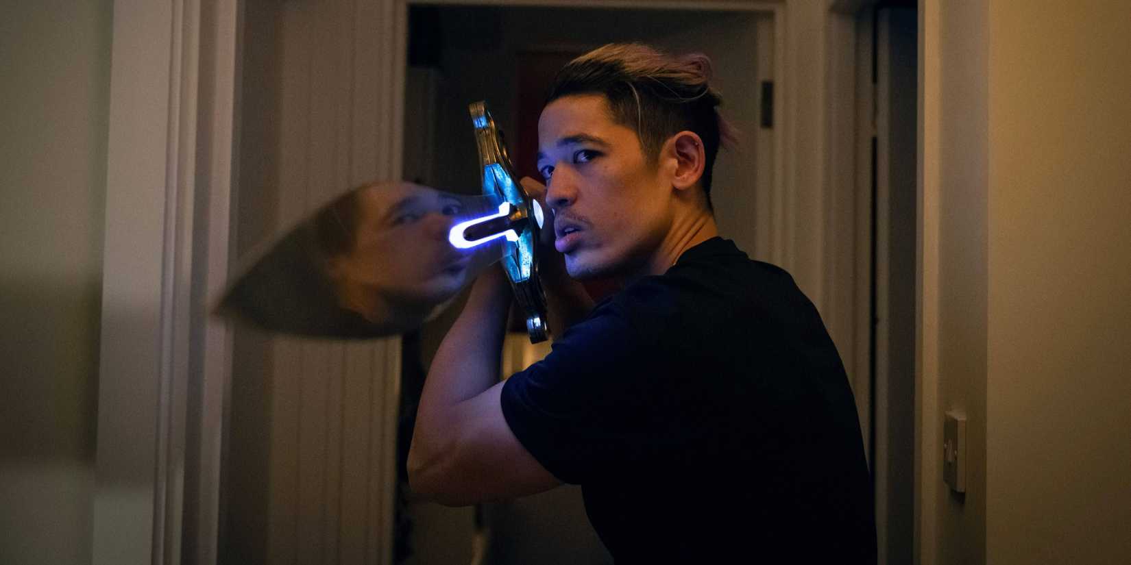 Roddy Ho (Christopher Chung) raising up a large sword in Slow Horses season 5, episode 2.