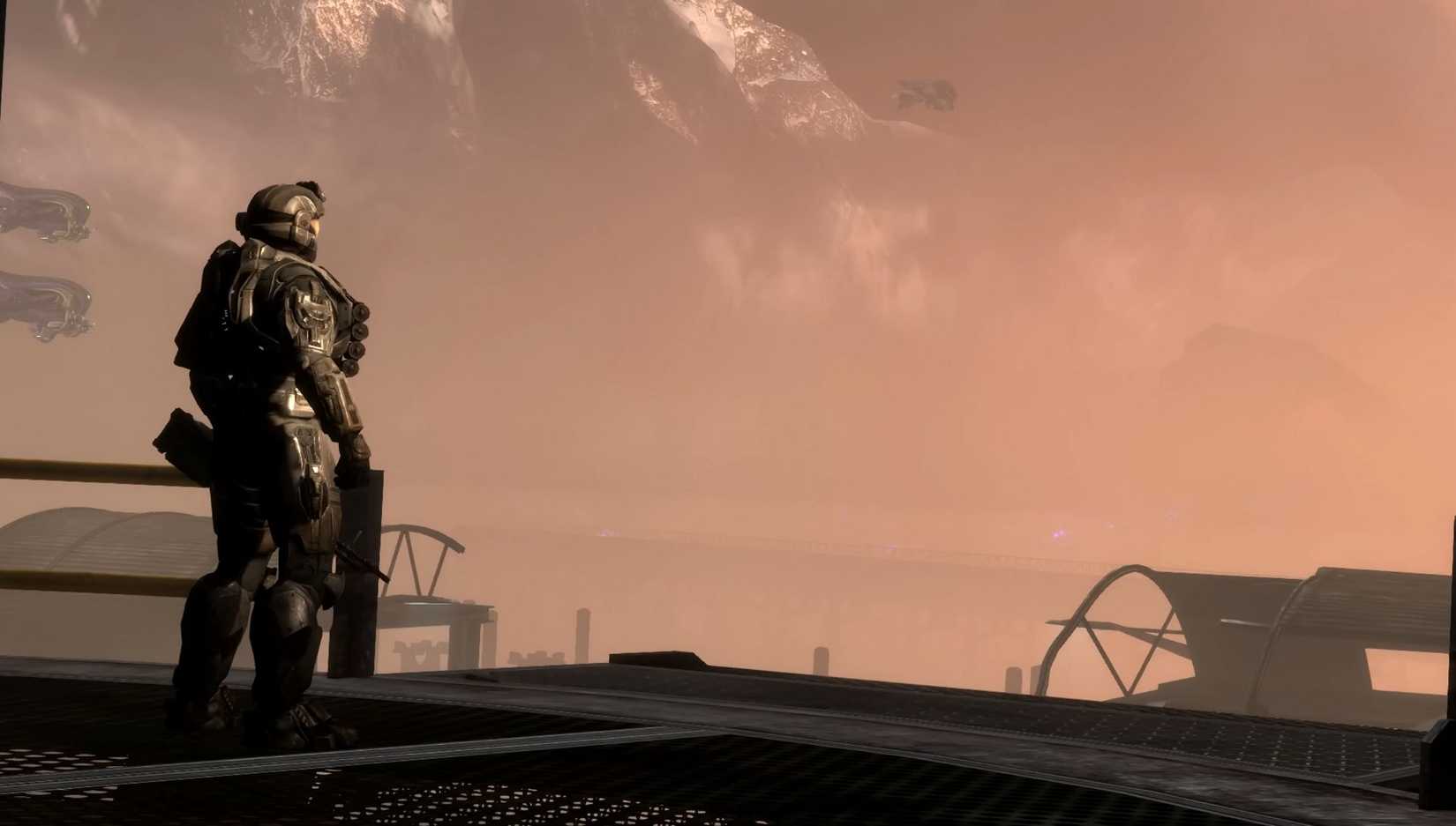 Soilder standing on a platform looking off at a ship in the distance in Halo Reach