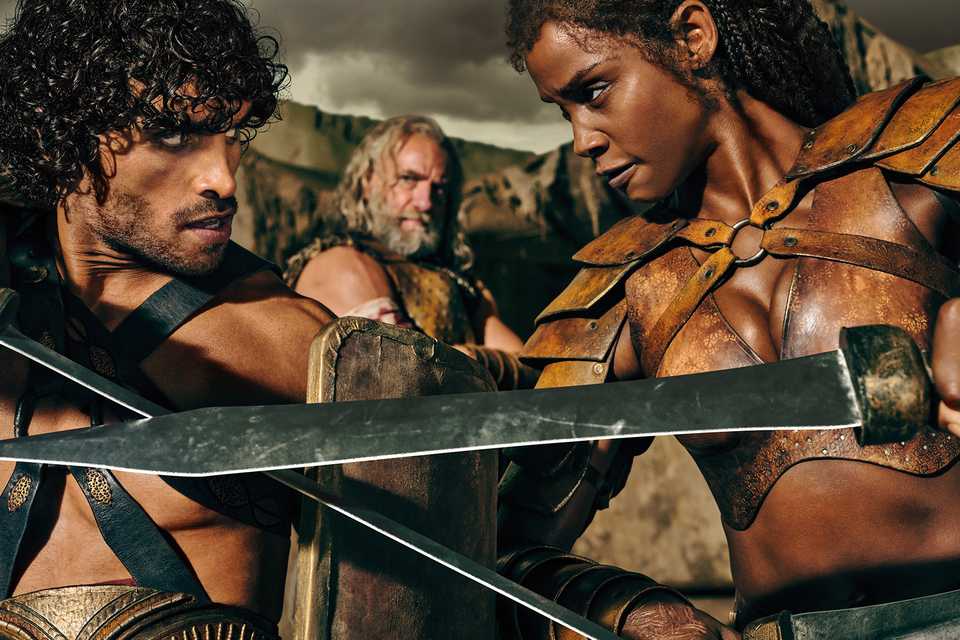 Tarchon and Achillia crossing blades while Korris watches in Spartacus: House of Ashur