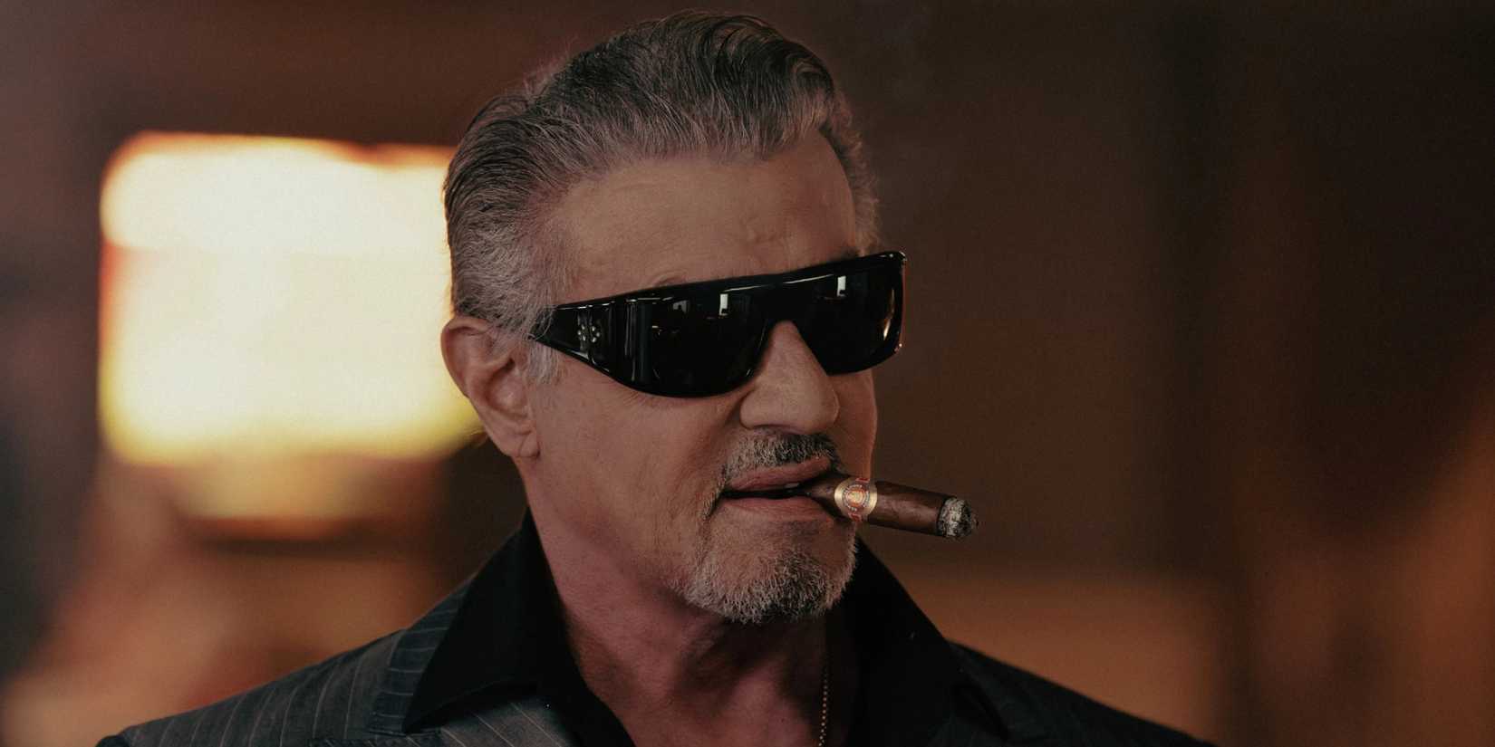 Sylvester Stallone as Dwight Manfredi smoking a cigar in Tulsa King