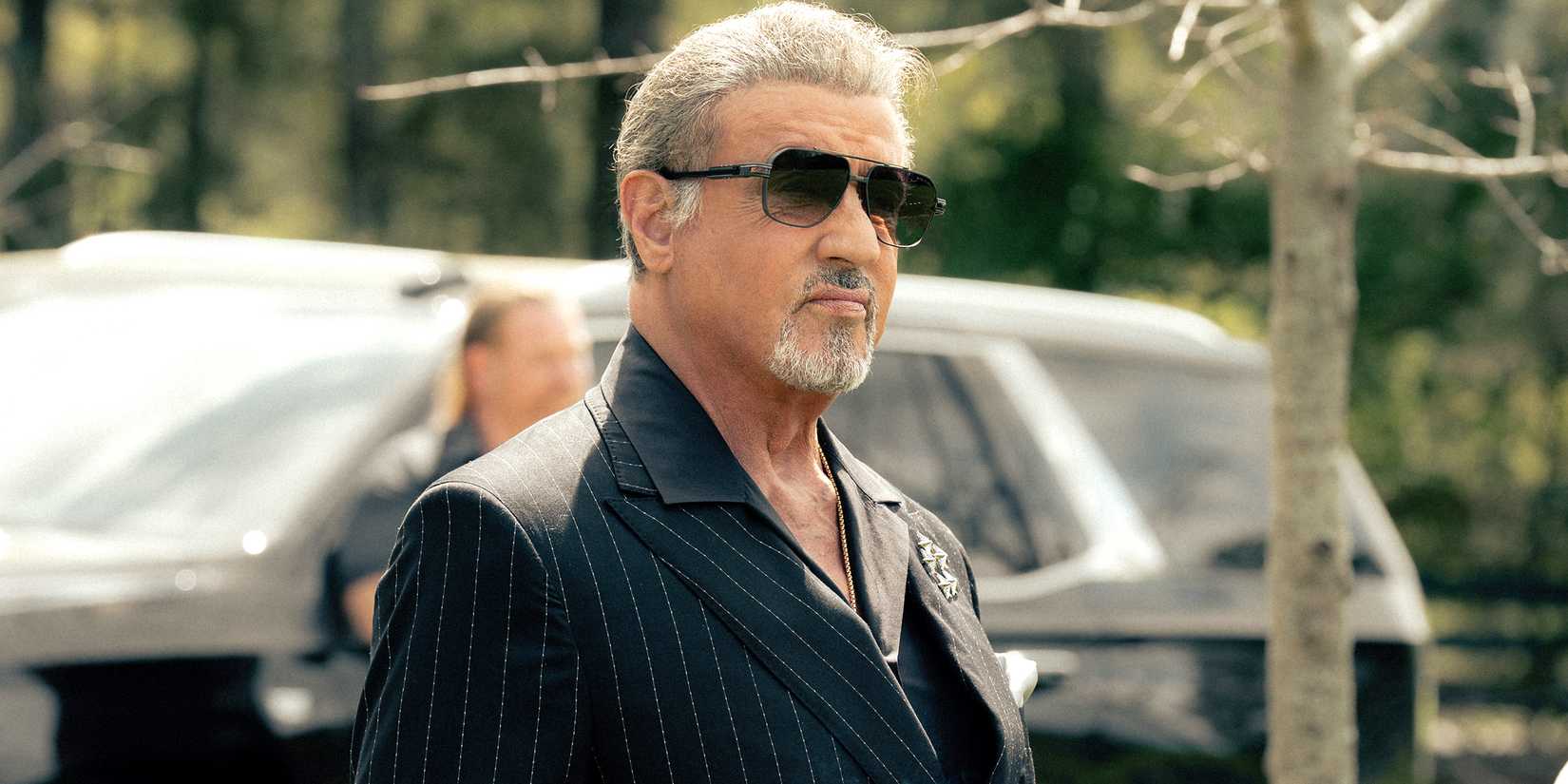 Sylvester Stallone's Dwight standing with a cigar in his hand in Tulsa King season 3