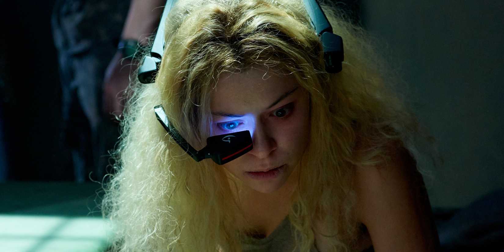 Tatiana Maslany as Helena staring through a sci-fi eyepiece in Orphan Black