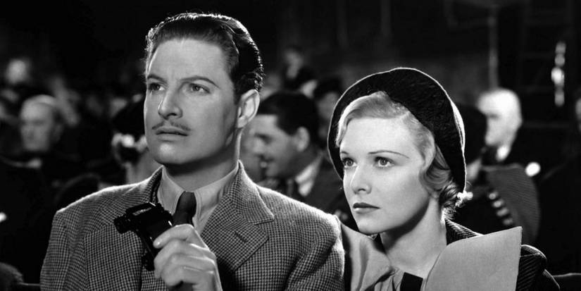 Hannay and Pamela watch something in a theater in The 39 Steps