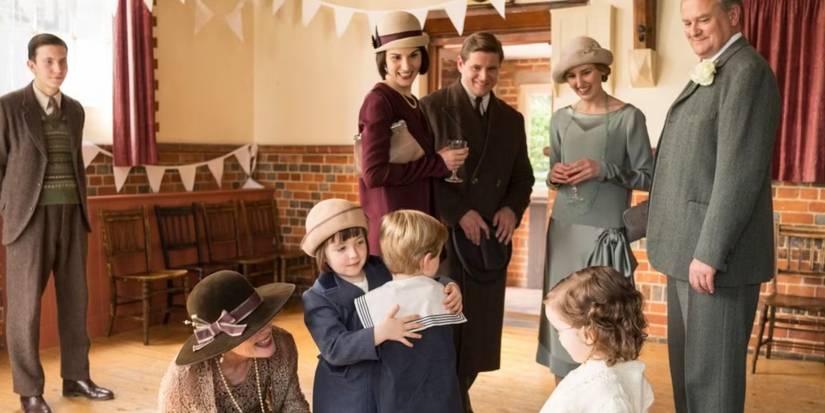 the adults smile at Sybbie and George as they hug in Downton Abbey season 6