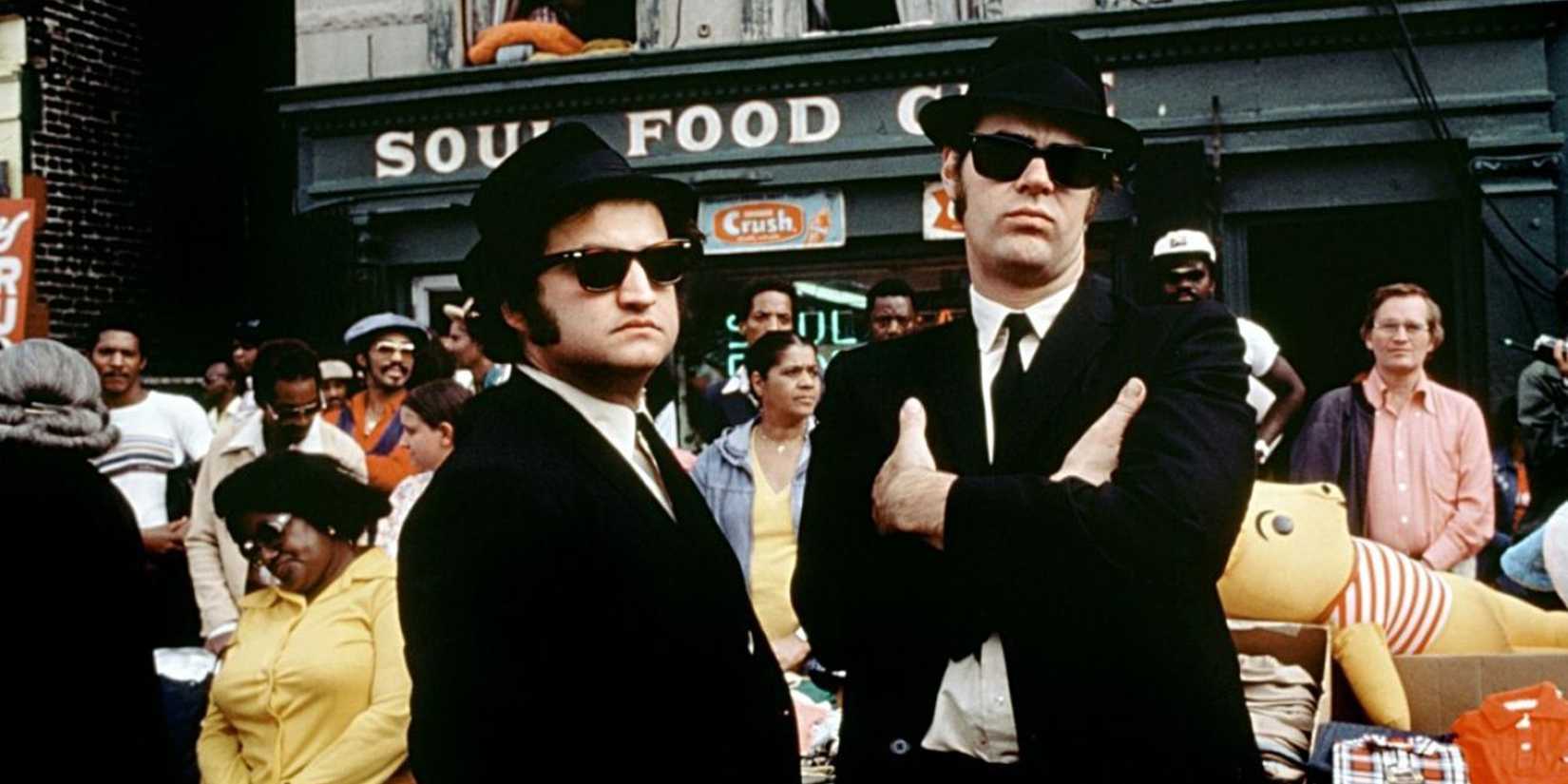 Jake and Elwood Blues stand in front of a crowd in The Blues Brothers
