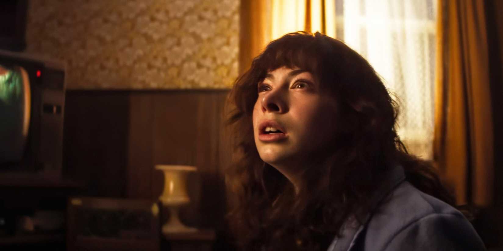 Heather Smurl sitting in front of a TV in The Conjuring: Last Rites.