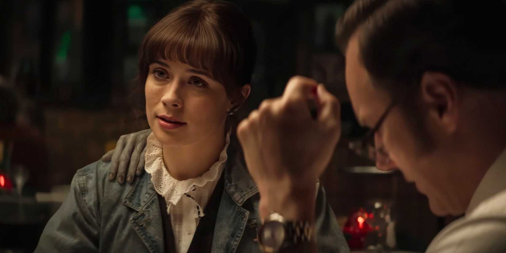 Judy Warren looking across the table at a restaurant in The Conjuring: Last Rites.