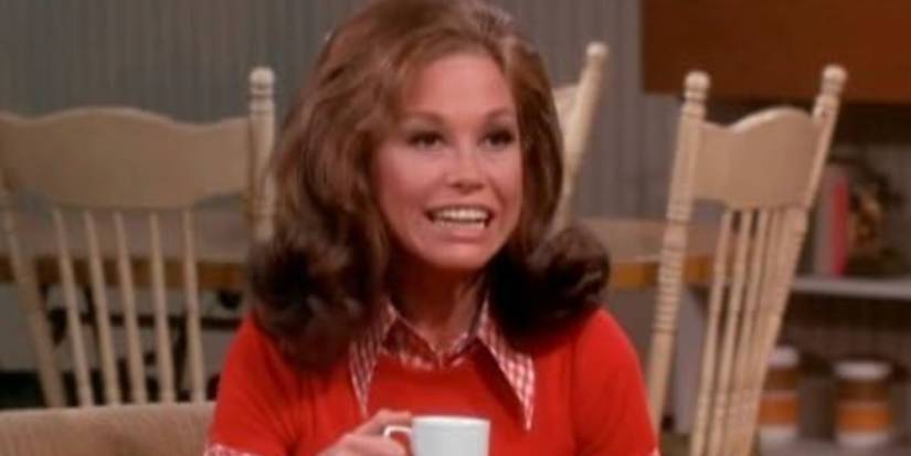 Mary Tyler Moore holding a cup of coffee in The Mary Tyler Moore Show