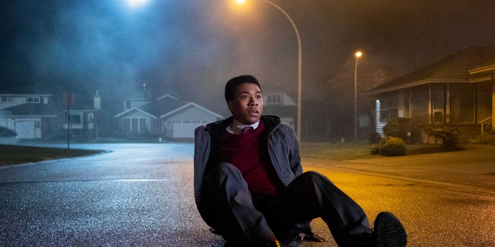 Spencer (William Chris Sumpter) sitting on the ground in The Midnight Club