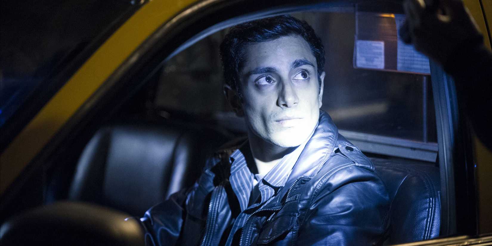 Naz (Riz Ahmed) having a light shone in his face in The Night Of.