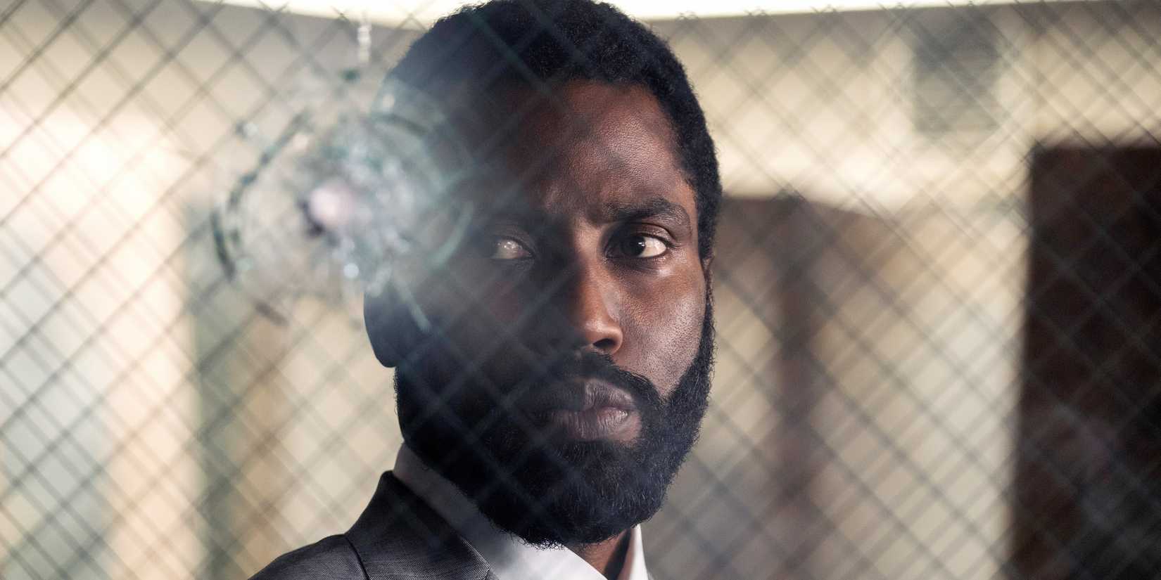 the protagonist staring at a bullet hole in glass in tenet