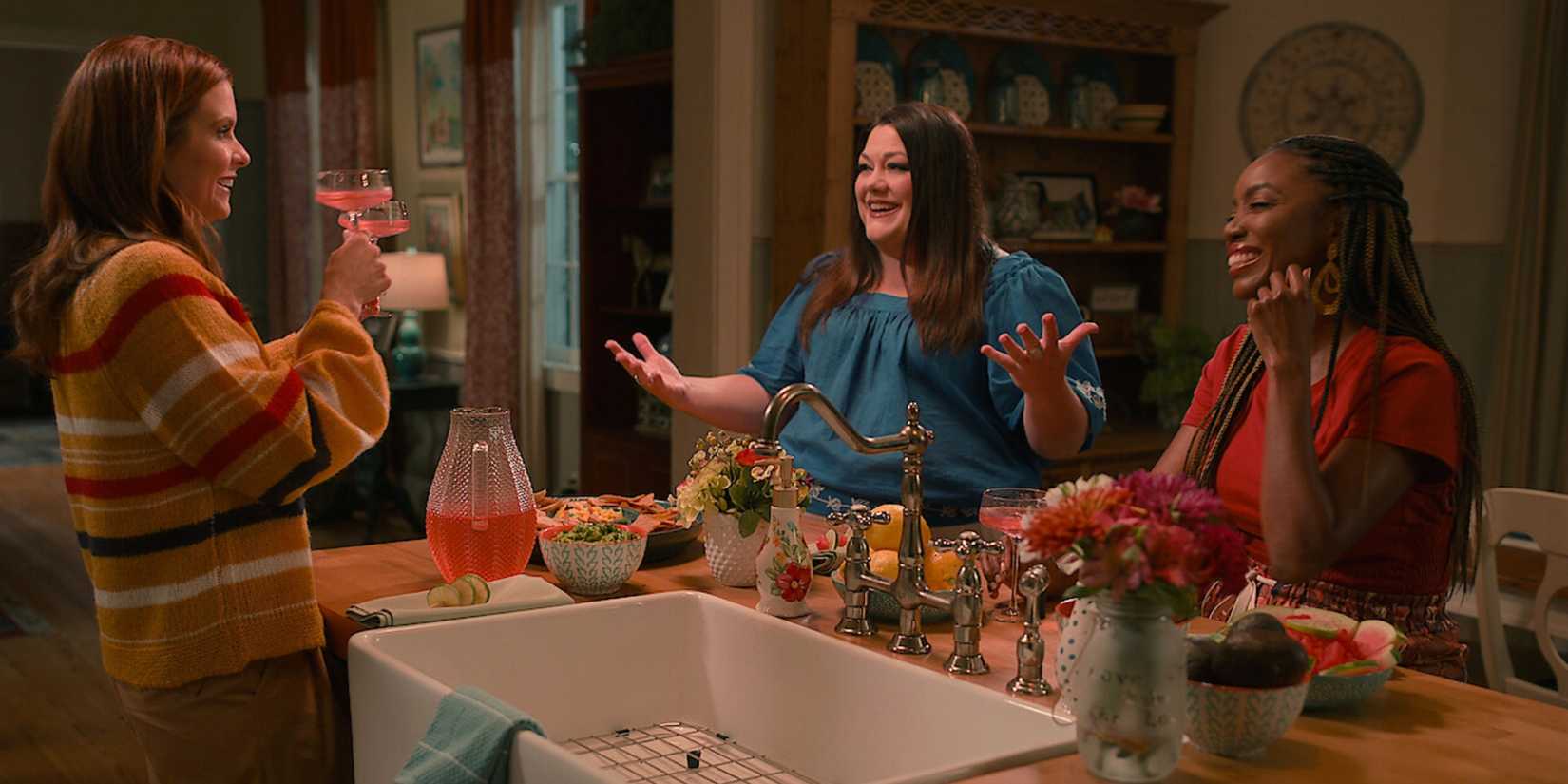 The Sweet Magnolias enjoying a pitcher of margaritas in a kitchen