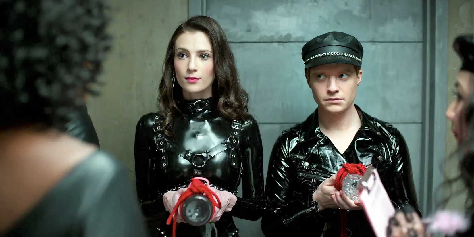 Tiff and Pete wearing leather at a party in the TV series Bonding