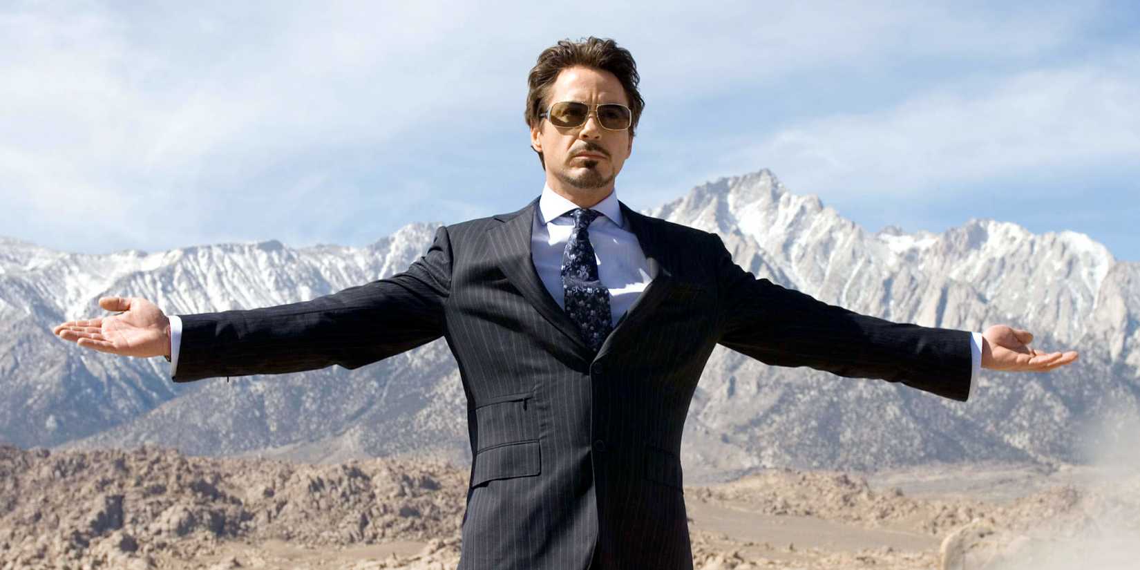 Tony Stark with his arms open in Iron Man (2008) opening scene