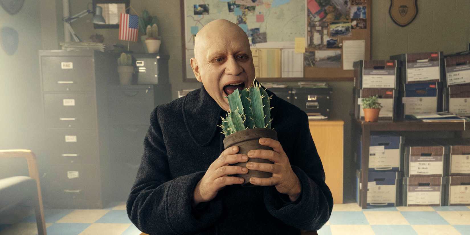Uncle Fester eating a cactus in Wednesday season 2