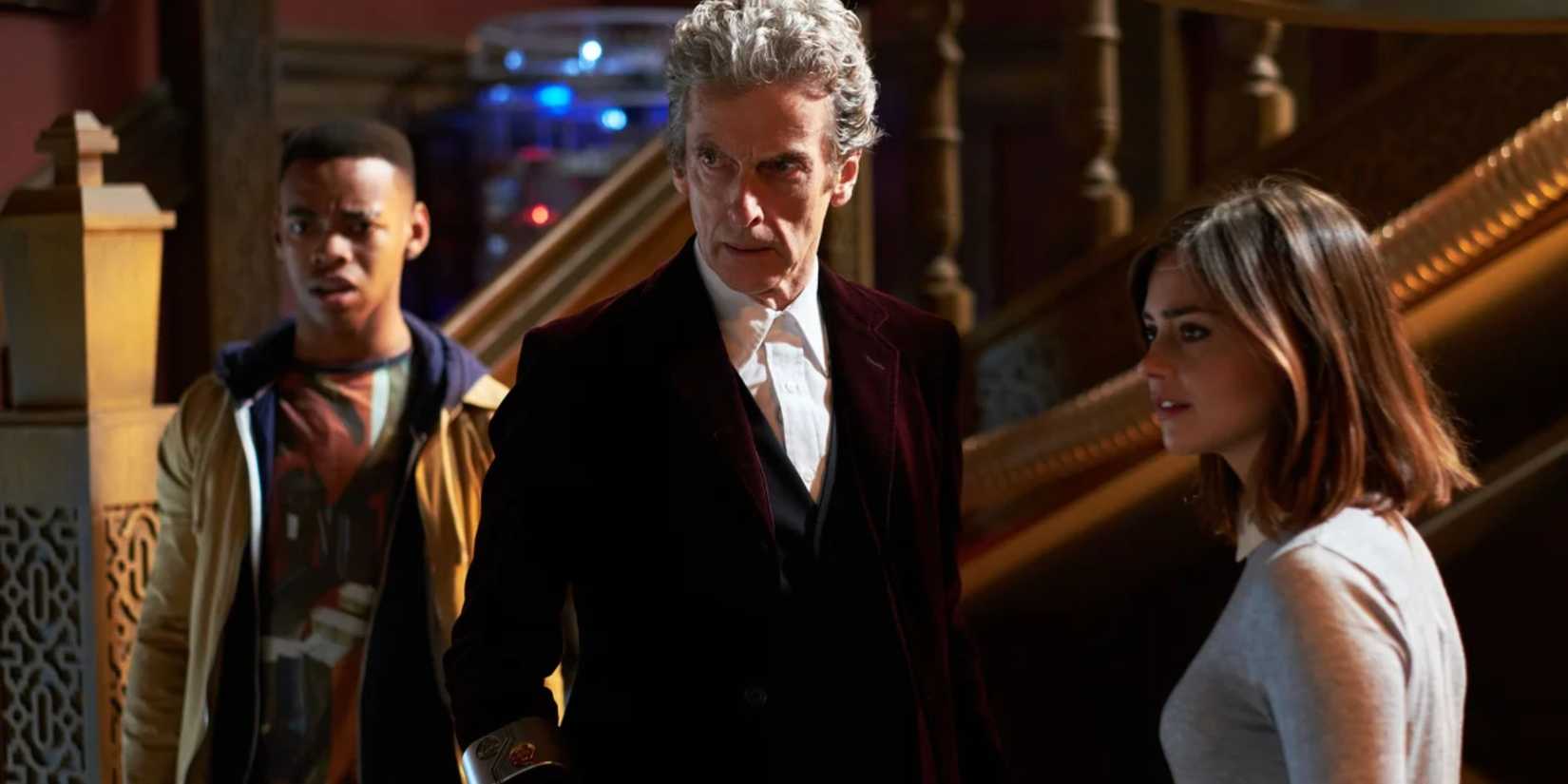 The Twelfth Doctor, Clara, and Rigsy standing together and staring at something in horror in the Doctor Who episode “Face the Raven.” 