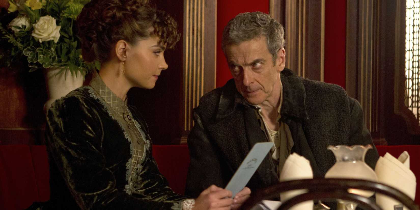 The Twelfth Doctor and Clara sitting in a restaurant, looking out for a clockwork droid, in the Doctor Who episode “Deep Breath.”  